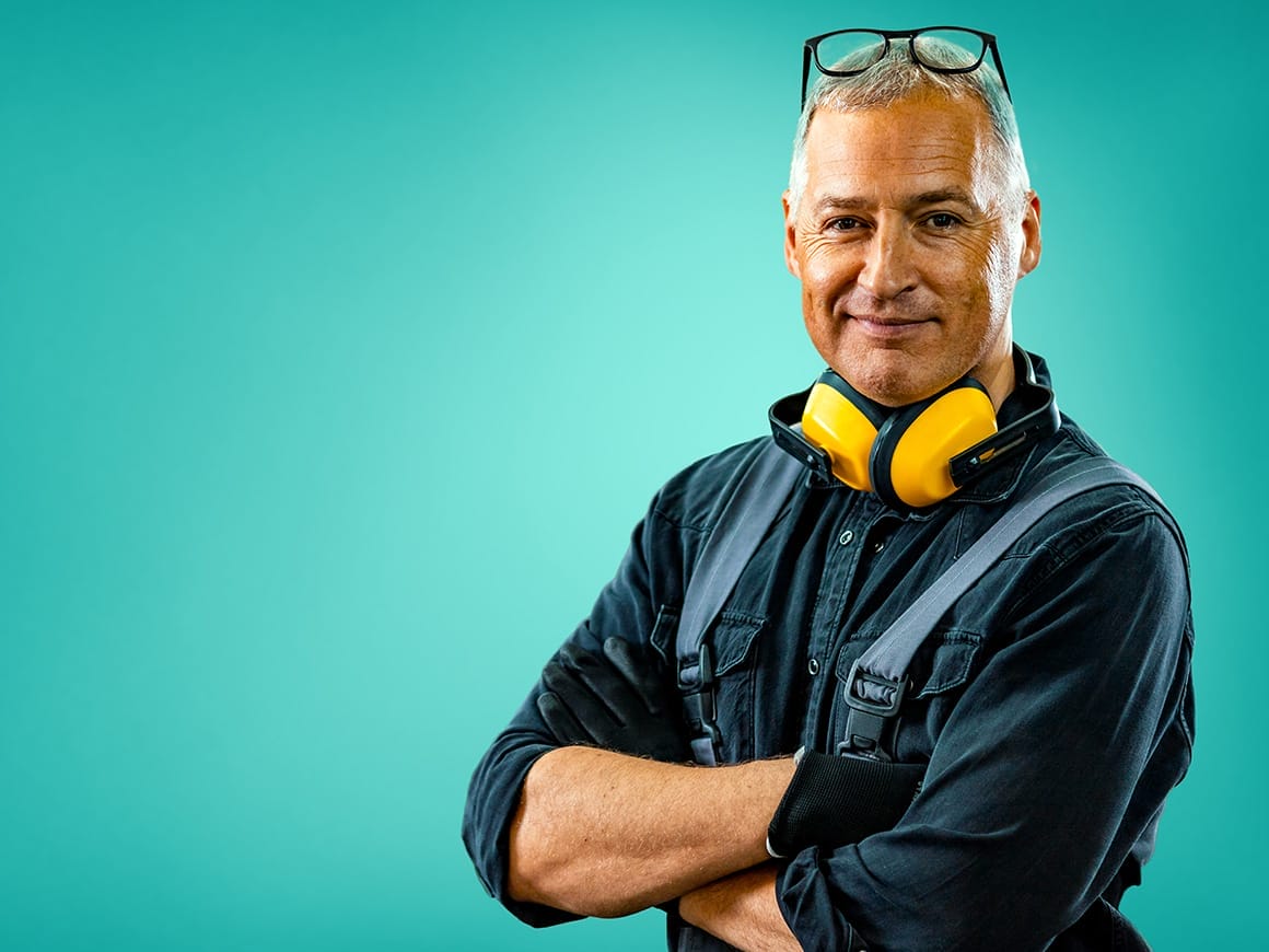 man wearing overalls and earphones